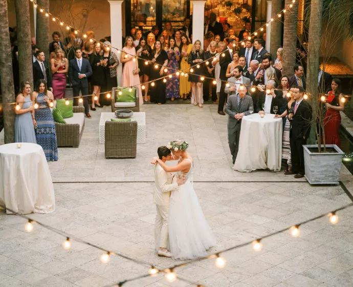 Wedding couple dancing in a courtyard
